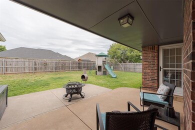 View of patio featuring a playground and a fire pi