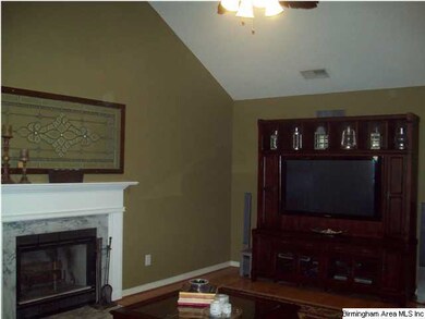 Cozy wood burning fireplace with marble surround