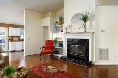 Kitchen, dining room and primary bedroom hallway view from great room