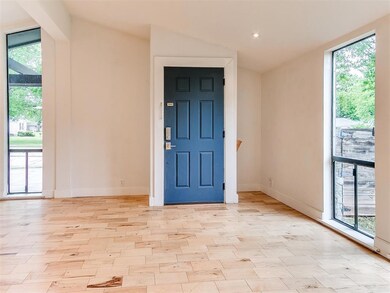 View of front entry, featuring vaulted ceilings, f
