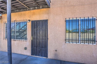 View of exterior entry with stucco siding