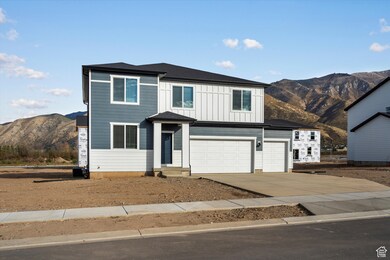 View of front of property featuring a mountain view, driveway, board and batten siding, a garage, and roof with shingles