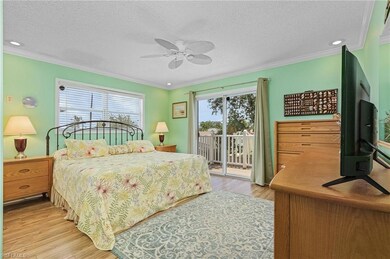 Bedroom featuring ceiling fan, light wood-type flo