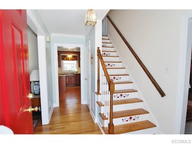 The Foyer Includes Hardwood Floors and Crown Mould