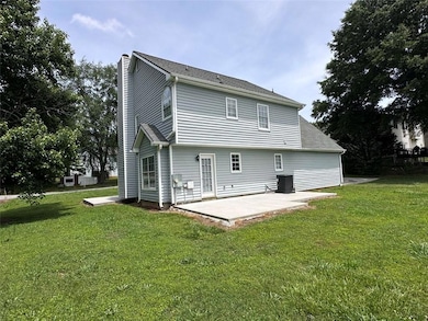 Back of property featuring a patio area, a chimney