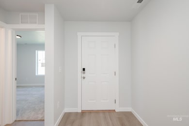 Foyer entrance featuring baseboards and light wood-style floors