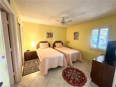 Bedroom with light tile patterned floors, a ceilin