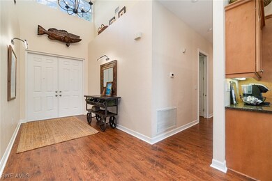 Entrance foyer featuring dark wood-style floors, b