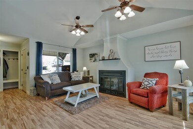 Vaulted ceiling and wood laminate flooring.