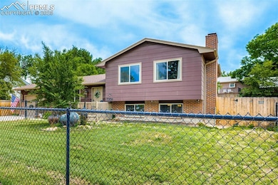 Tri-level home with a chimney and brick siding
