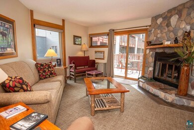 Carpeted living room with a wall unit AC, a textur