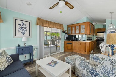 Living area featuring vaulted ceiling with beams, 