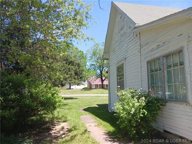 Side view of house and sidewalk