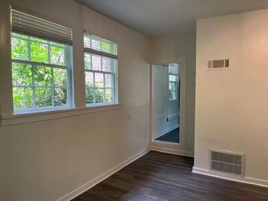 Unfurnished room with dark wood-style flooring, vi