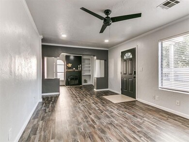 Spacious living room with canned lighting and wood