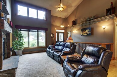Great room with vaulted ceiling. This front wall of windows fills the room with natural light.