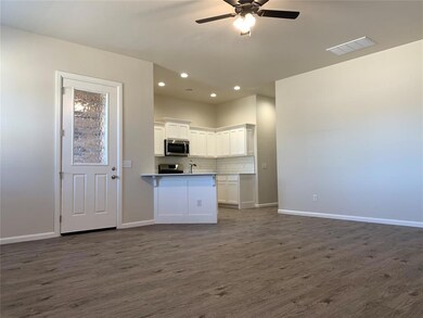 Kitchen featuring white cabinets, backsplash, dark wood-type flooring, open floor plan, and recessed lighting