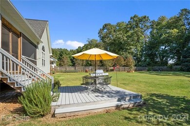 Patio area overlooking fenced in backyard