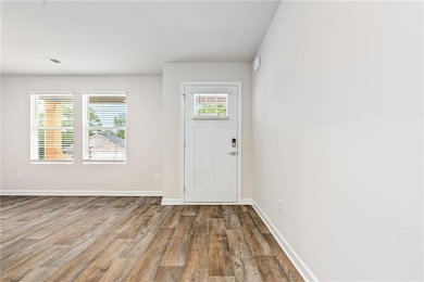 Foyer entrance with wood finished floors and baseboards