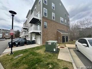View of side of home featuring a balcony