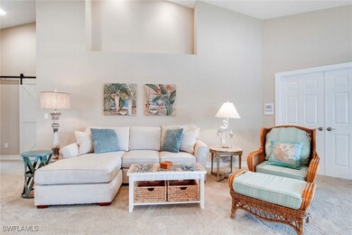 Living room featuring a barn door, a towering ceil