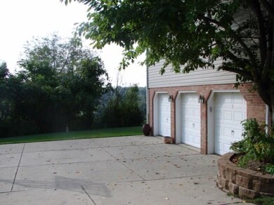 This beauty offers a three car garage with keyless