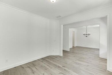 Empty room with light wood finished floors, basebo