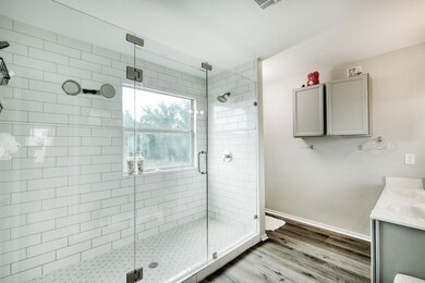 Full bathroom with a stall shower, wood finished 