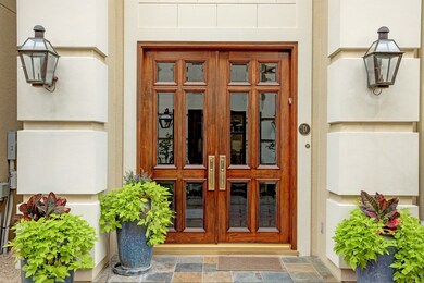 A welcoming entry with stately, wooden double door