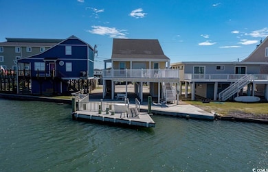 Dock area with stairway, a deck with water view, a patio area, and a residential view