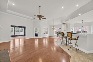 Living room with ornamental molding, lofted ceilin