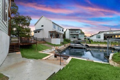 Rear view of property featuring a deck with water
