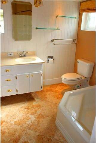 Enjoy the oversized soaking tub, travertile tile f