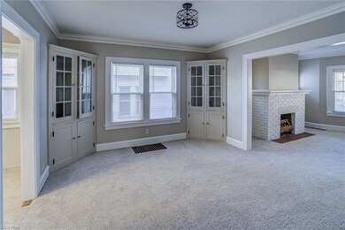 Downstairs apartment has built in cabinets in dining room, updated lighting, freshly painted, new carpeting and flows into living room
