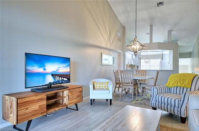 Living room featuring a high ceiling, wood-type fl
