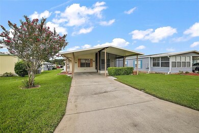 Front view of property, carport area, screened porch and covered patio