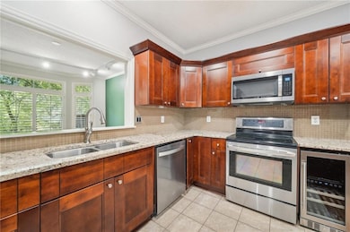 Kitchen featuring a sink, beverage cooler, crown m
