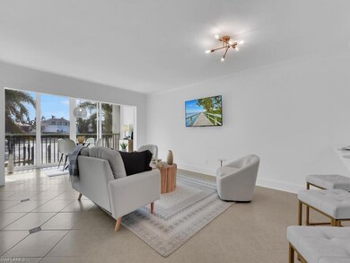 Tiled living room featuring a notable chandelier a