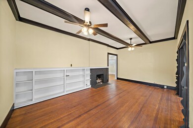 Fireplace is decorative (non functioning). Note the beams in the ceiling and solid wood floors throughout! So much CHARM in this unit #2!