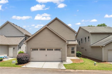 View of front of house featuring an attached garage and driveway