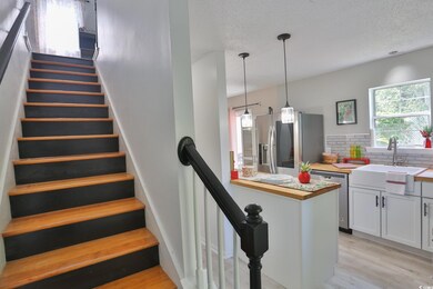 Stairs with sink, light hardwood / wood-style floo