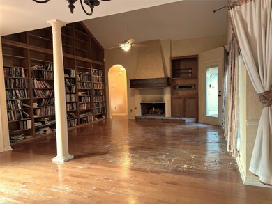 Unfurnished living room featuring ceiling fan, har