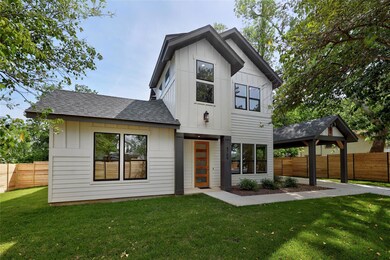 View of front of home featuring a front lawn, fen