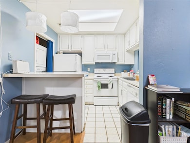 Kitchen featuring white appliances, white cabinet