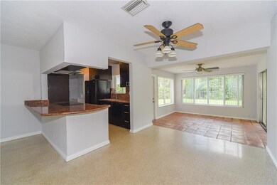 Eat in kitchen area opens into sunroom/den