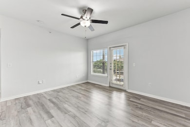 Spare room with ceiling fan, wood finished floors