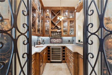 Beautiful 8' tall arched-top iron gates open into