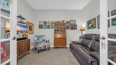 Carpeted living area with baseboards
