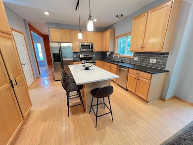 Kitchen with maple floors and cabinets