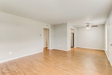 Spare room with light wood-type flooring and a ceiling fan